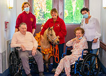 Image of Mini Horse with staff and residents