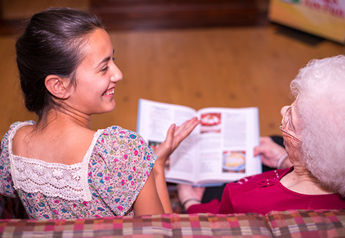 A volunteer and a resident share time together in Westview's North Wing Lounge